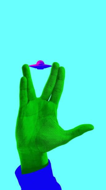 istock Green hand making Vulcan salute, with a miniature UFO floating above it against turquoise background. Contemporary art collage. 2185144540