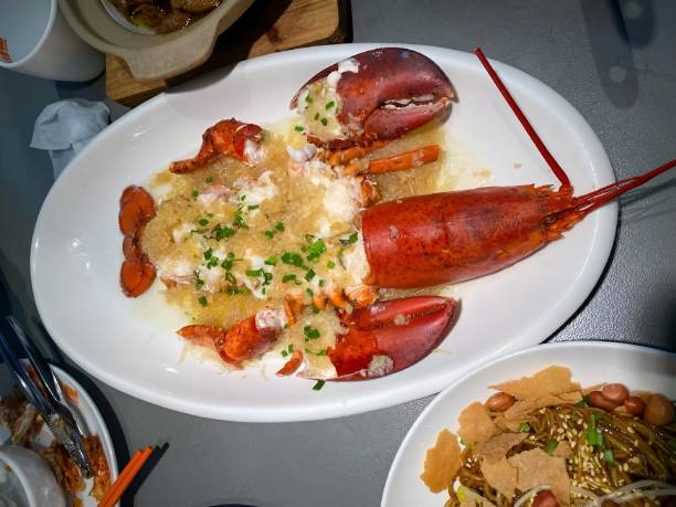 istock Lobster with Garlic Vermicelli on a white plate on table with other items 2185144854