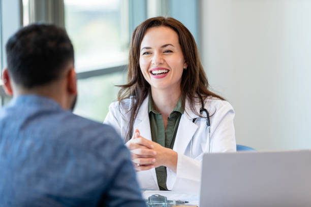 istock Cheerful doctor talks with male patient 2185146479