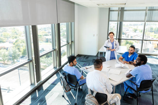 istock Female doctor leads staff meeting 2185146499