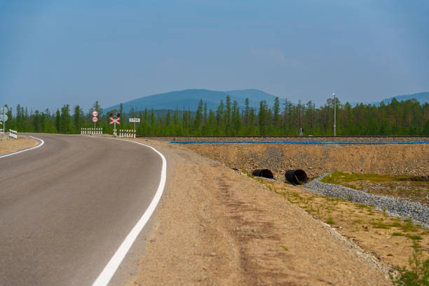 istock Empty road approaching railway crossing in rural area 2185147448