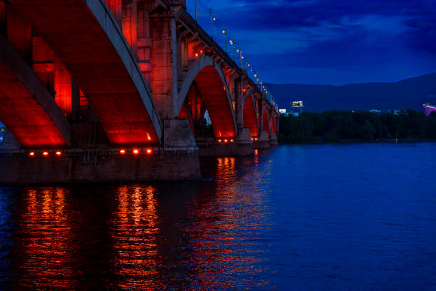 istock Illuminated bridge over river at dusk with reflections on wate 2185147615