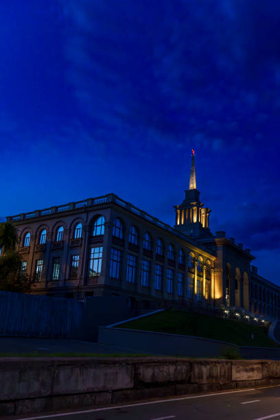 istock Historic building with large windows illuminated at dusk 2185147664