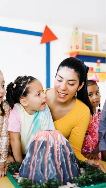 istock Teacher and children learning science at kindergarten or daycare. Diverse kids studying at school. Education concept 2185149276