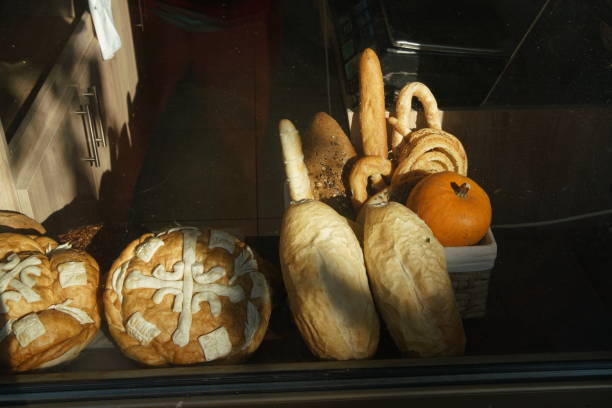 Various types of bread on all shop window in a Manchester suburb . Pumpkin is also a sign of autumn