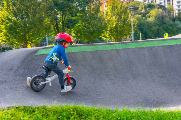 istock A young boy is riding a bike down a hill 2185154707