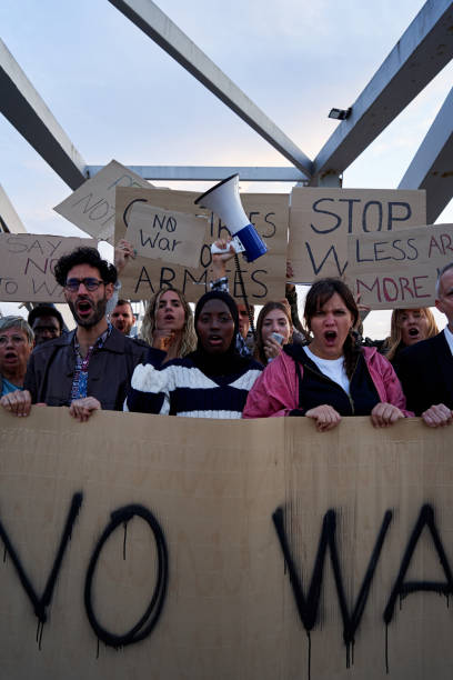 istock Multiracial group of people protesting, screaming Stop War with banners against violence. 2185157661