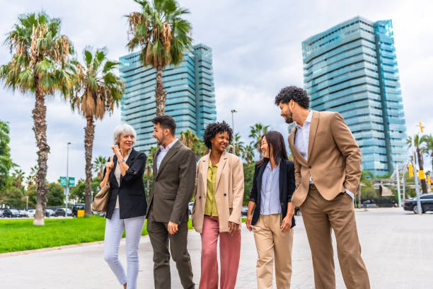 istock Multi-ethnic colleagues walking along financial district talking relaxed 2185158026