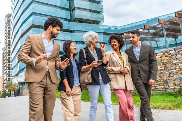 istock Multi-ethnic business people chatting relaxed walking along financial district 2185158041