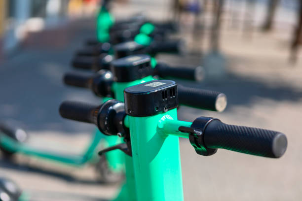 istock Green scooters parked neatly along the sidewalk 2185158075