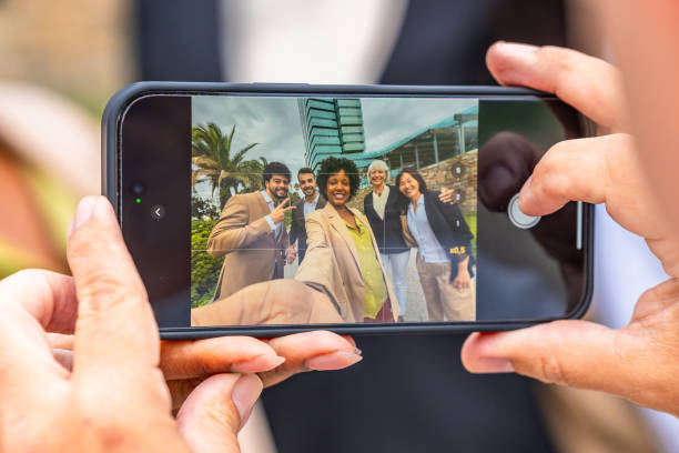 Screen of the mobile while business people taking a selfie