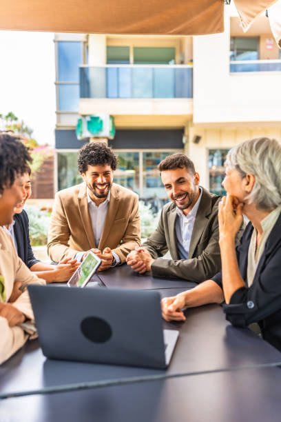 istock Diverse business people using laptop during a meeting at cafeteria 2185158149