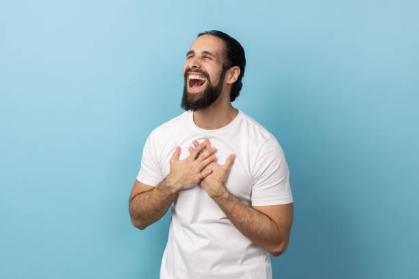 istock Man keeps hands on chest closes eyes and expressing positive emotions. 2185161428