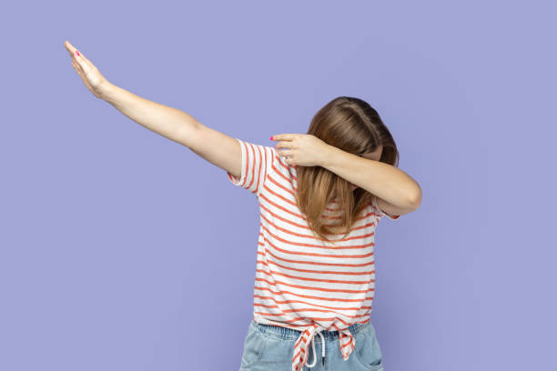 istock Dark haired anonymous woman standing in dab dance pose, internet meme, celebrating success. 2185161477