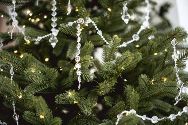 istock Decorated Christmas tree with lights and crystal garlands in cozy home setting 2185162738