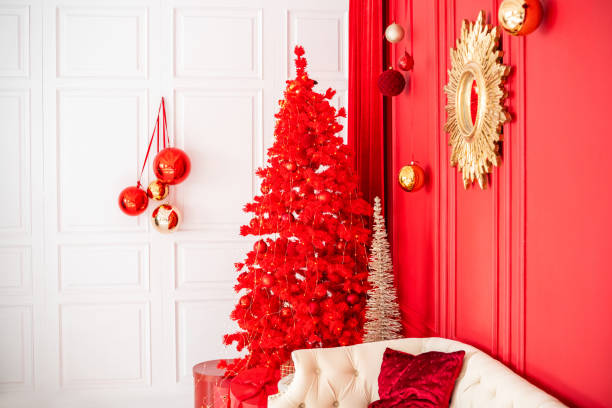 Festive red Christmas tree decorates a cozy living space in winter