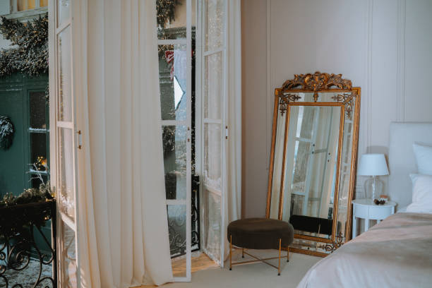 istock Elegant bedroom with open windows and ornate mirror in a cozy setting 2185163033