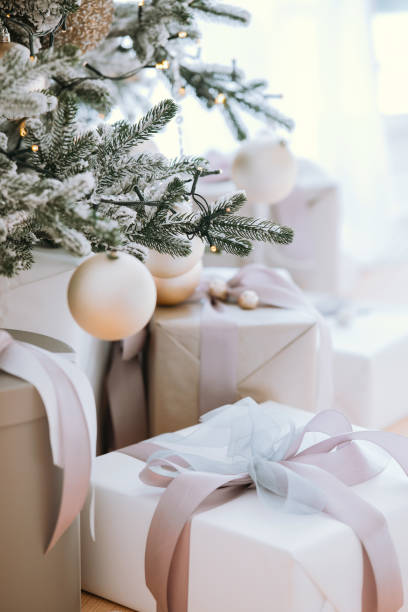 istock Christmas tree adorned with ornaments and beautifully wrapped presents indoors 2185163091