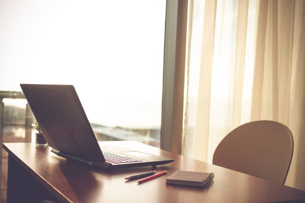 istock Online working at home using a laptop. Cozy workplace near window 2185171527