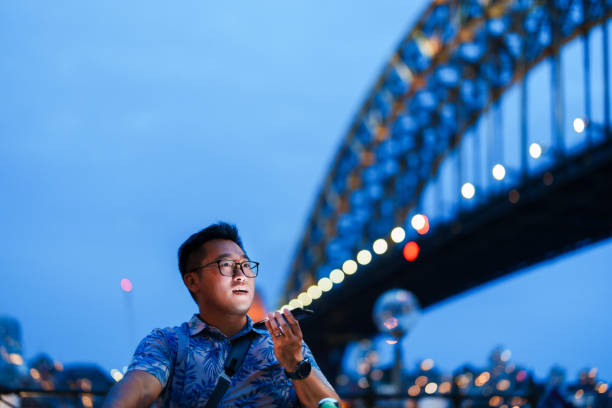 istock Mobile delight under the bridge, Sydney serenity. 2185179225