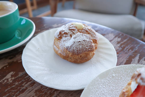 istock choux cream or cream puff, eclair and coffee 2185179496