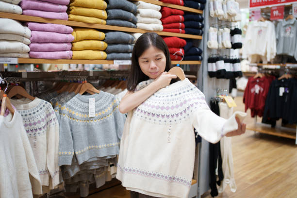 istock Asian woman shopping for clothes 2185181690