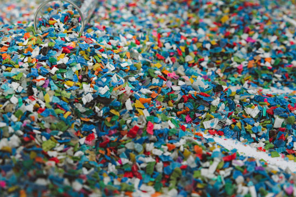 istock Hands hold clear white plastic pellets, raw materials for various manufacturing processes. These pellets are widely used in industries to produce products like packaging, bottles, and equipment parts. The white background highlights the pellets, making th 2185182485