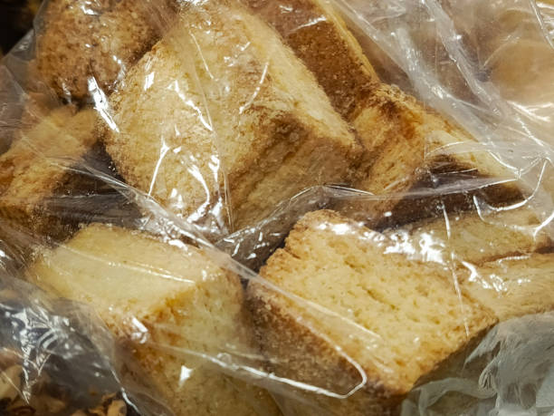 istock Square, bread rusks sprinkled with crumbs in a transparent bag. Background, space for dough. Sandwich toasts. 2185183081