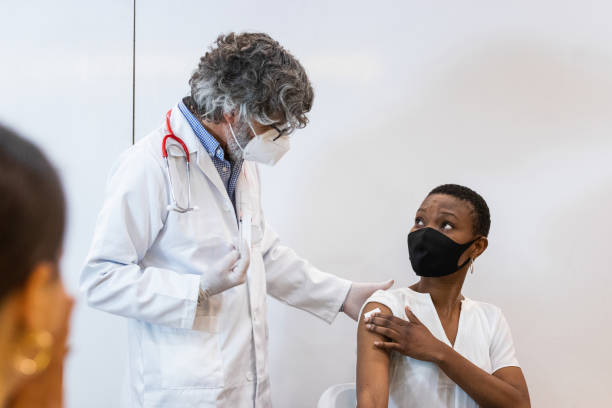 istock Doctor making injection for black woman patient 2185188391