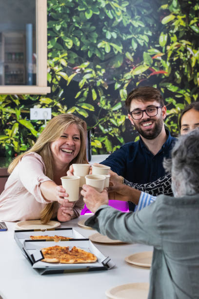 istock Diverse colleagues having lunch together in kitchen of office 2185188420