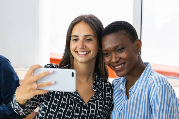 istock Smiling multiethnic coworkers taking selfie during break in office 2185188434