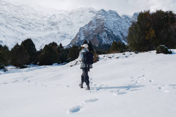 An Asian woman climbs a snow mountain