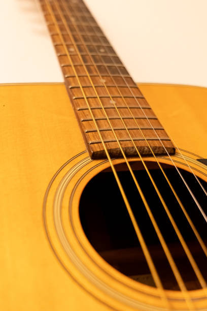 Acoustic guitar placed casually on the sofa in a cozy living room, conveying a peaceful and comfortable atmosphere.