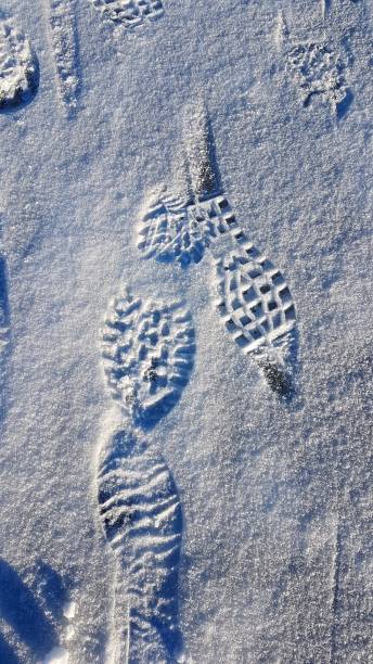 istock Footprints on a frozen lake in the mountains during a hike. 2185192865
