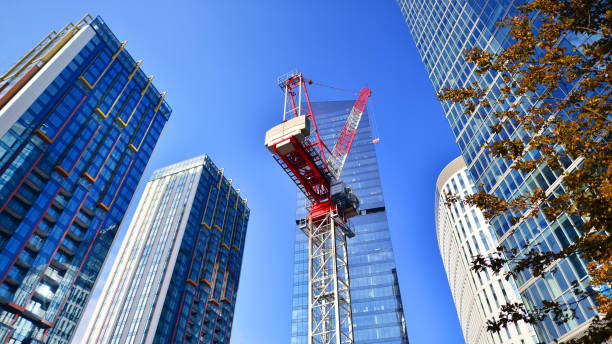 istock Crane on the construction site in a site surrounded by the high buildings. 2185193282