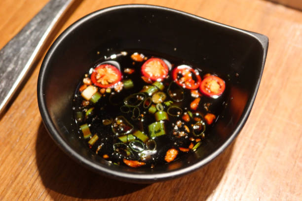 istock spicy chilli pepper spring onion soy sauce in a black dish for dipping hot pot with copy space 2185193748