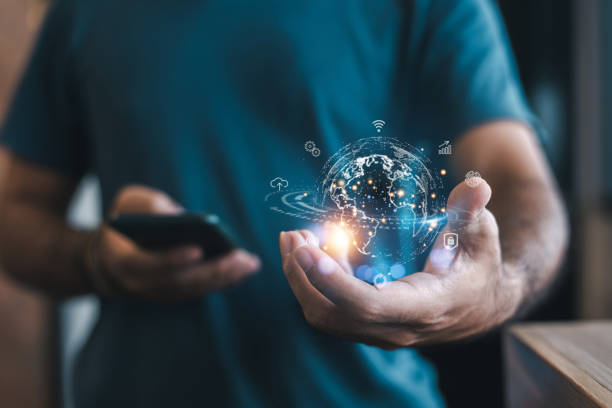 istock Man Holding Digital Globe with Smartphone 2185193993