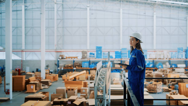 Female Engineer Overseeing Warehouse Operations in Safety Gear