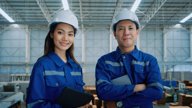 istock Asian Professional Engineers Smiling in a Factory Setting 2185195512