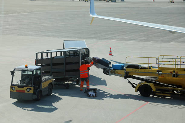 istock baggage handler wearing high visibility reflective suit unloading bags at the international airport 2185196258