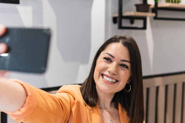 istock Cheerful woman taking selfie on smartphone in cafe 2185196934