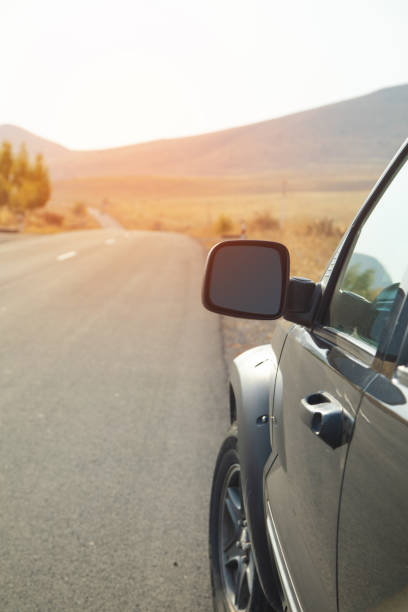 istock Car driving on the road. Car mirror 2185199133