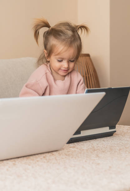 istock Smiling Toddler Engaging With Technology In A Warm And Modern Home Space 2185199696