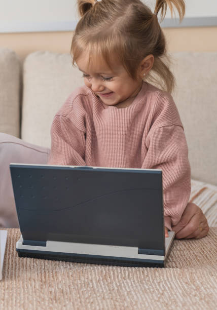 istock Beautiful Little Girl Using Modern Technology At Home For Fun And Learning 2185199767