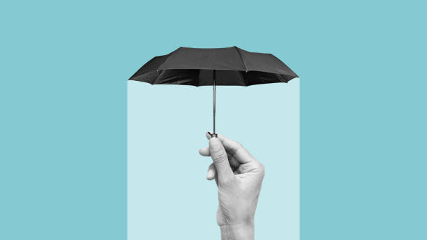 istock Hiding under an umbrella from problems symbolizing insurance, support and protection. The concept of protection of health and wealth. Copy space 2185200081