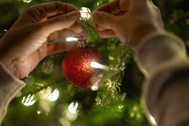 istock Close-up of a woman's hands decorating Christmas tree 2185204205