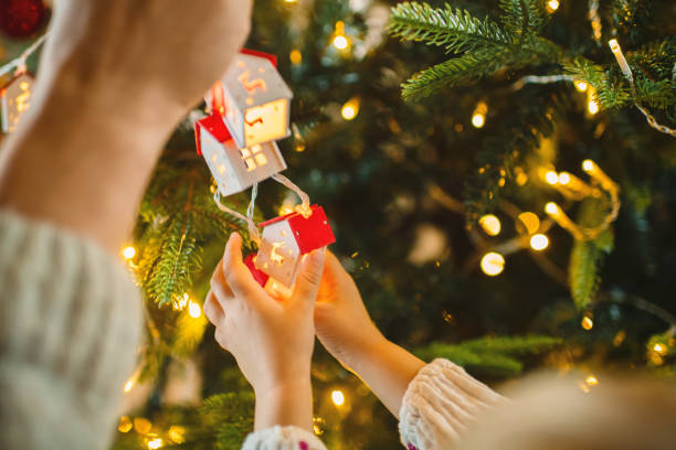 istock Family decorating Christmas tree at home 2185204267
