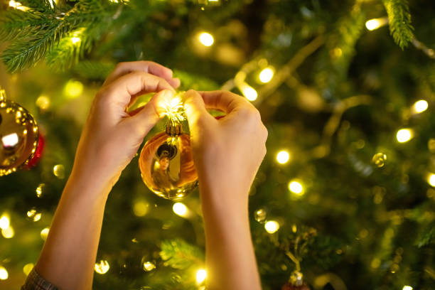 Child at home decorating Christmas tree