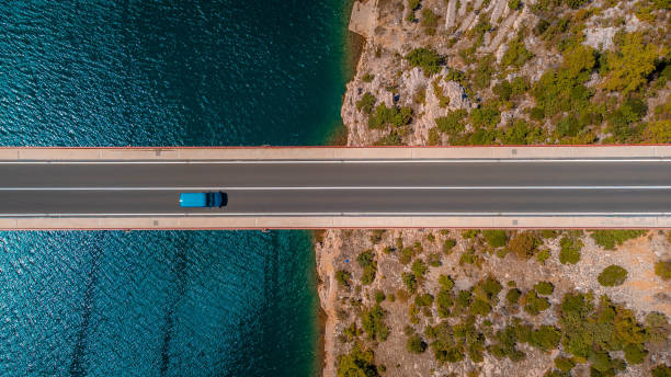 istock Top down view blue car travelling over a bridge 2185204993