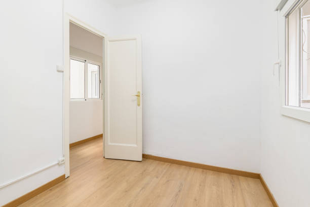 istock Light compact room with a small window and white walls with an open front door. The concept of buying budget housing or a hostel room. Copyspace 2185206953